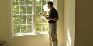 Man checking on energy efficiency of windows